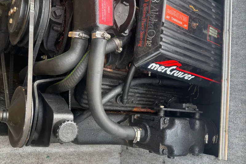 Slide: The Image of Engine compartment of a 1991 Sea Ray 220 boat with MerCruiser components. - 14