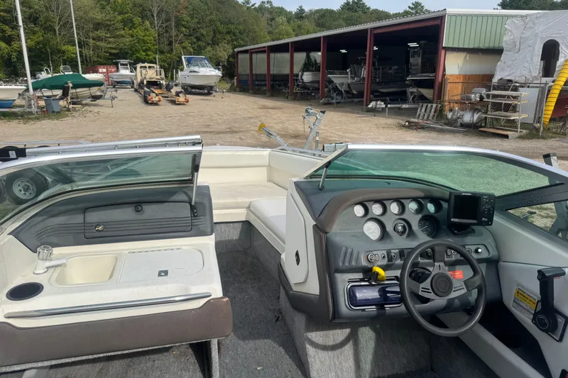 Slide: The Image of Interior view of a 1991 Sea Ray 220 boat with dashboard and seating area. - 2