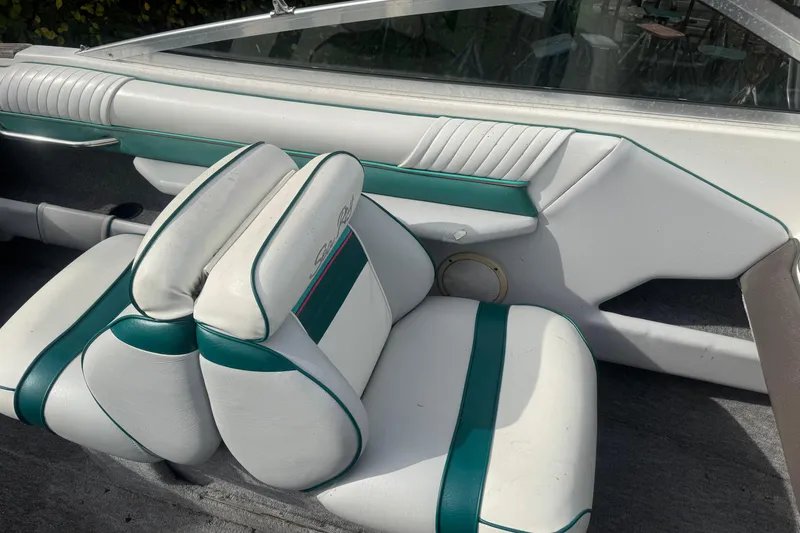 Slide: The Image of 1991 Sea Ray 220 boat interior with white and teal seating. - 5