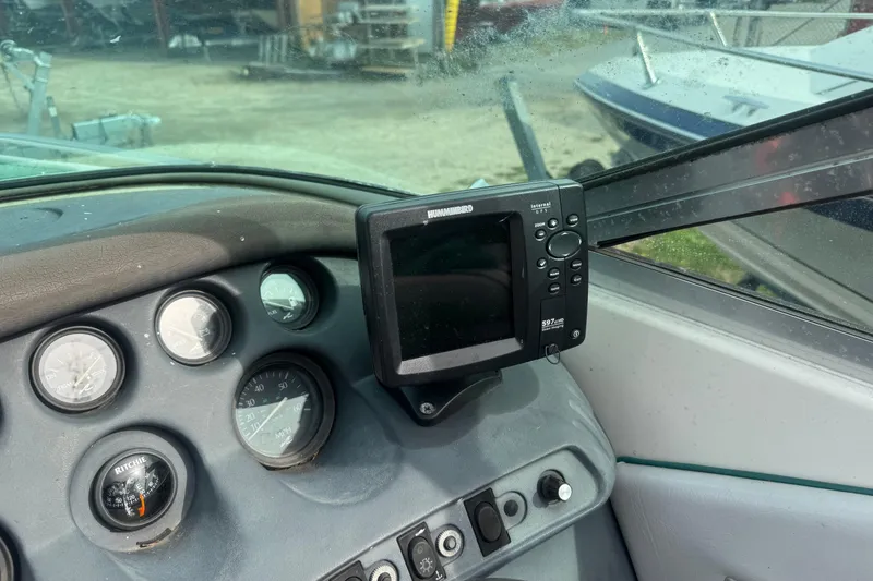 Slide: The Image of 1991 Sea Ray 220 boat dashboard with gauges and Humminbird fish finder. - 7