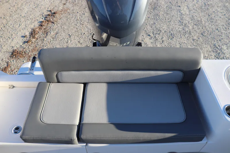 Slide: The Image of 2024 Sea Born LX22 Center Console boat seat with gray upholstery and outboard motor. - 10