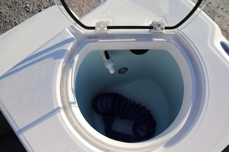 Slide: The Image of 2024 Sea Born LX22 Center Console livewell with coiled hose inside. - 11