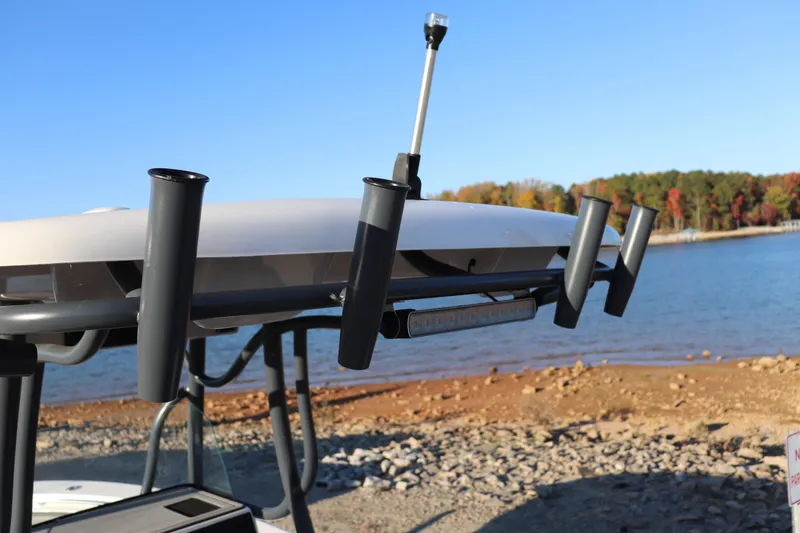 Slide: The Image of 2024 Sea Born LX22 Center Console boat with rod holders by a lake. - 13