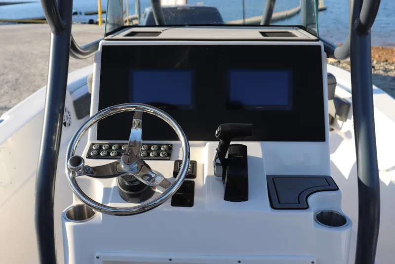 Slide: The Image of 2024 Sea Born LX22 Center Console boat dashboard with steering wheel and controls. - 8