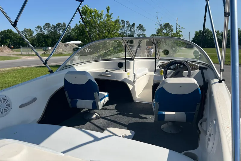 Slide: The Image of 2000 Wellcraft Capri boat with Mercury outboard motor on trailer, blue canopy. - 12