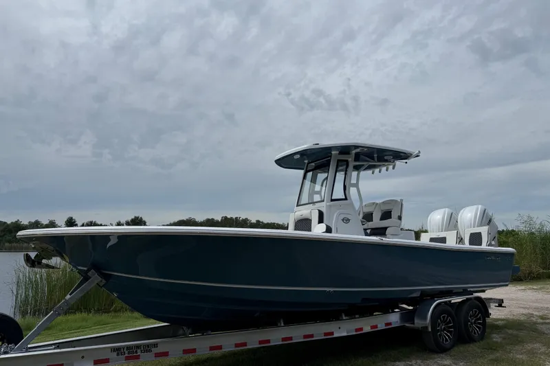 Slide: The Image of 2026 Tidewater 2700 Carolina Bay boat on trailer under cloudy sky. - 10