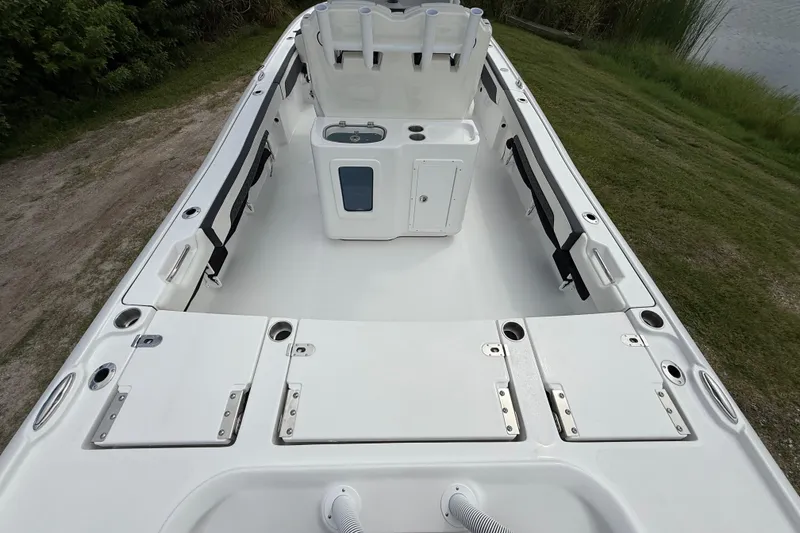 Slide: The Image of 2026 Tidewater 2700 Carolina Bay boat interior with storage compartments and seating. - 13