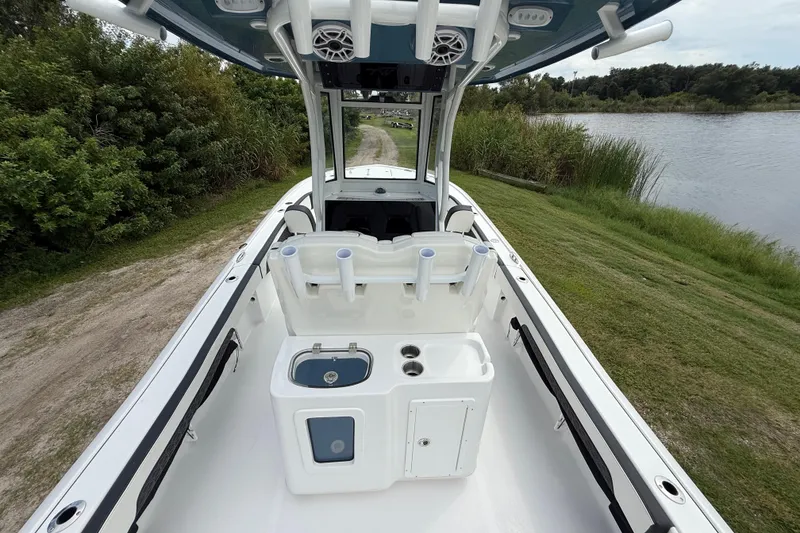 Slide: The Image of 2026 Tidewater 2700 Carolina Bay boat interior with fishing rod holders and storage compartments. - 15