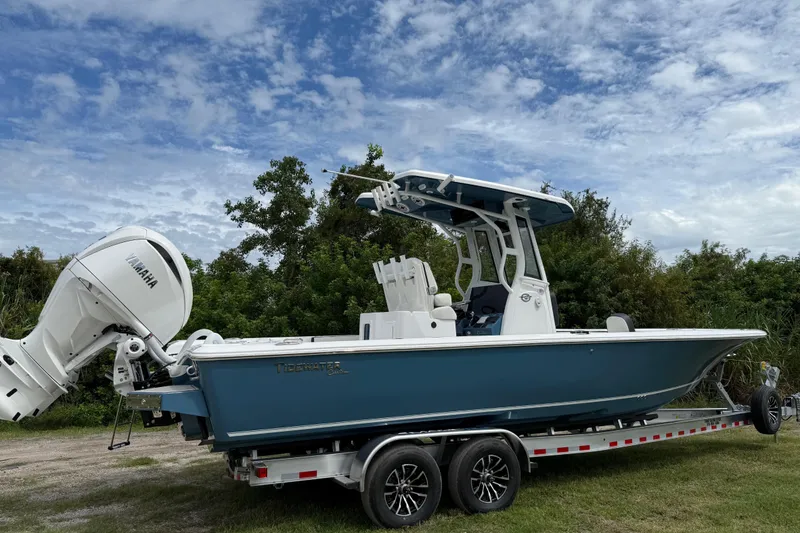 Slide: The Image of 2026 Tidewater 2700 Carolina Bay boat on trailer, featuring Yamaha outboard motor. - 2
