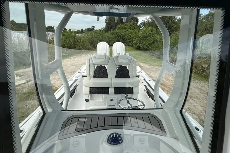 Slide: The Image of 2026 Tidewater 2700 Carolina Bay boat interior with dual seats and steering wheel. - 23
