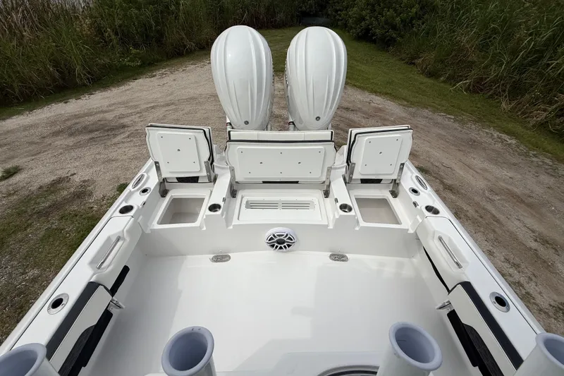 Slide: The Image of 2026 Tidewater 2700 Carolina Bay boat with open storage compartments and dual engines. - 27