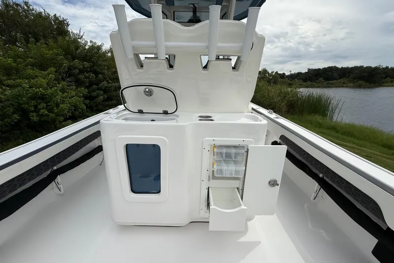 Slide: The Image of 2026 Tidewater 2700 Carolina Bay boat interior with storage compartments and rod holders. - 33