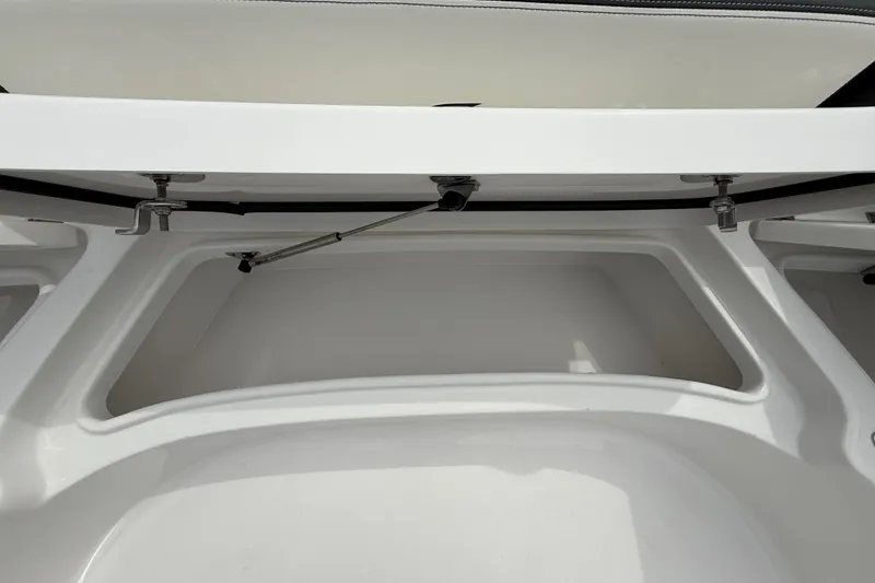 Slide: The Image of 2026 Tidewater 2700 Carolina Bay storage compartment, open lid, showcasing spacious interior design. - 44