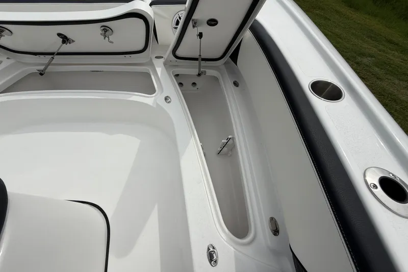 Slide: The Image of 2026 Tidewater 2700 Carolina Bay boat interior storage compartments and cup holders. - 45