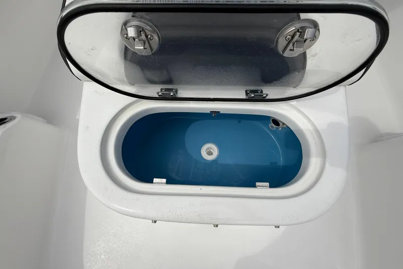 Slide: The Image of Livewell compartment on 2026 Tidewater 2700 Carolina Bay boat, open lid view. - 49
