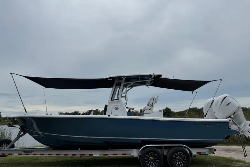 Slide: The Image of 2026 Tidewater 2700 Carolina Bay boat on trailer with canopy, side view. - 50