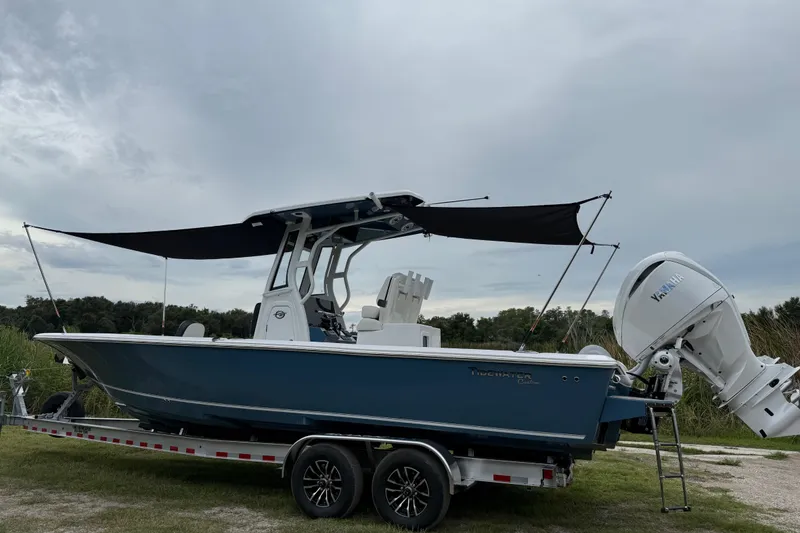 Slide: The Image of 2026 Tidewater 2700 Carolina Bay boat on trailer with Yamaha engine, parked outdoors. - 54