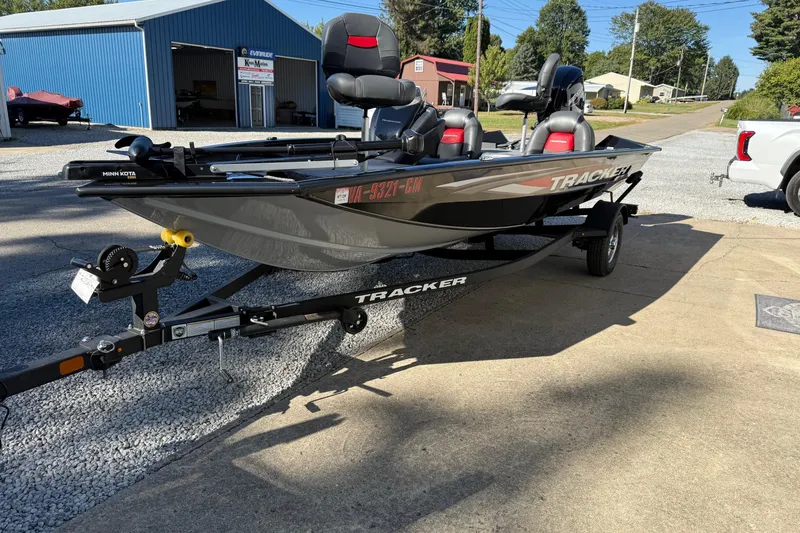 Slide: The Image of 2025 Tracker Pro Team 175 boat on trailer, parked outside a blue garage. - 11
