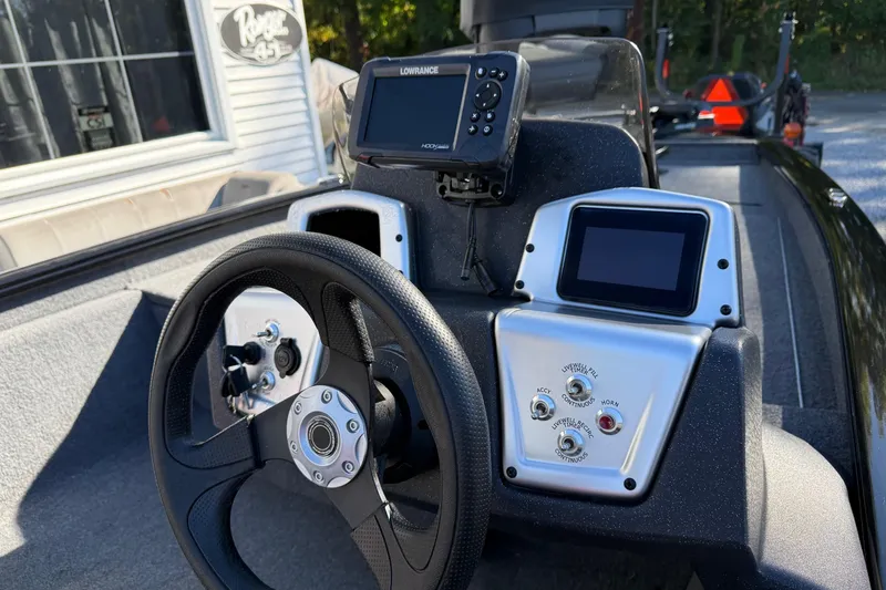 Slide: The Image of 2025 Tracker Pro Team 175 boat dashboard with steering wheel and electronic displays. - 5