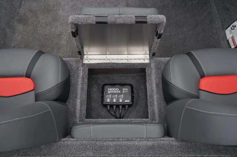 Slide: The Image of Manufacturer Provided Image: 2025 Tracker Pro Team 175 boat interior with NOCO Genius battery charger between seats. - 52