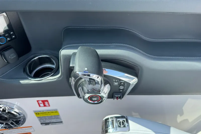 Slide: The Image of Control panel of 2025 Chaparral 247 SSX boat with throttle and cup holder. - 16