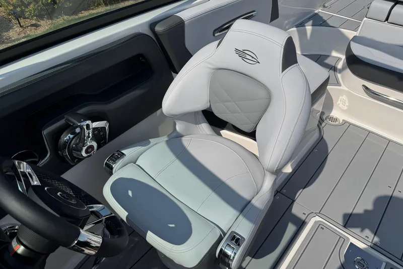 Slide: The Image of 2025 Chaparral 247 SSX boat interior with modern steering and luxurious seating. - 17