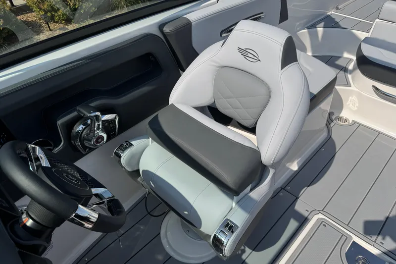 Slide: The Image of 2025 Chaparral 247 SSX boat interior with modern steering and luxurious seating. - 18