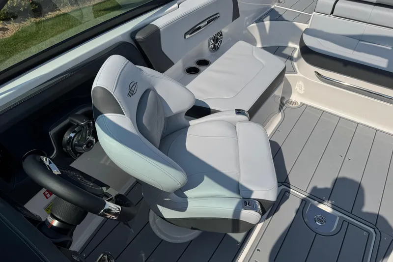 Slide: The Image of 2025 Chaparral 247 SSX boat interior with sleek seating and modern steering wheel. - 19
