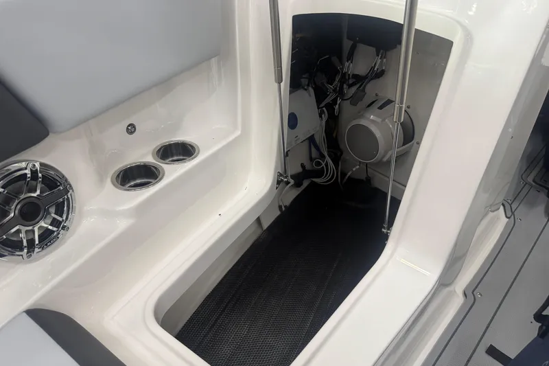 Slide: The Image of 2025 Chaparral 247 SSX boat interior with speaker and storage compartment. - 23