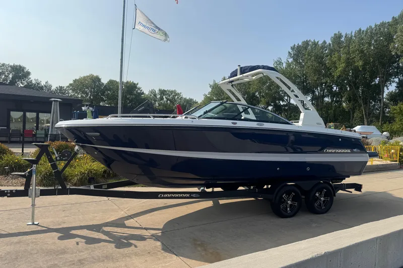 Slide: The Image of 2025 Chaparral 247 SSX boat on trailer, displayed outdoors with trees in background. - 3