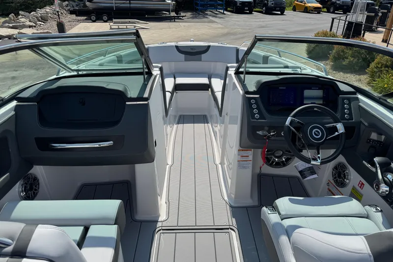 Slide: The Image of Interior view of 2025 Chaparral 247 SSX boat, featuring modern dashboard and seating. - 35