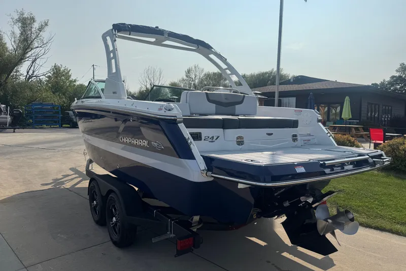Slide: The Image of 2025 Chaparral 247 SSX boat on trailer, parked outdoors, rear view. - 4