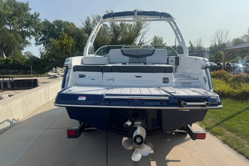 Slide: The Image of 2025 Chaparral 247 SSX boat, rear view, docked on a sunny day. - 6