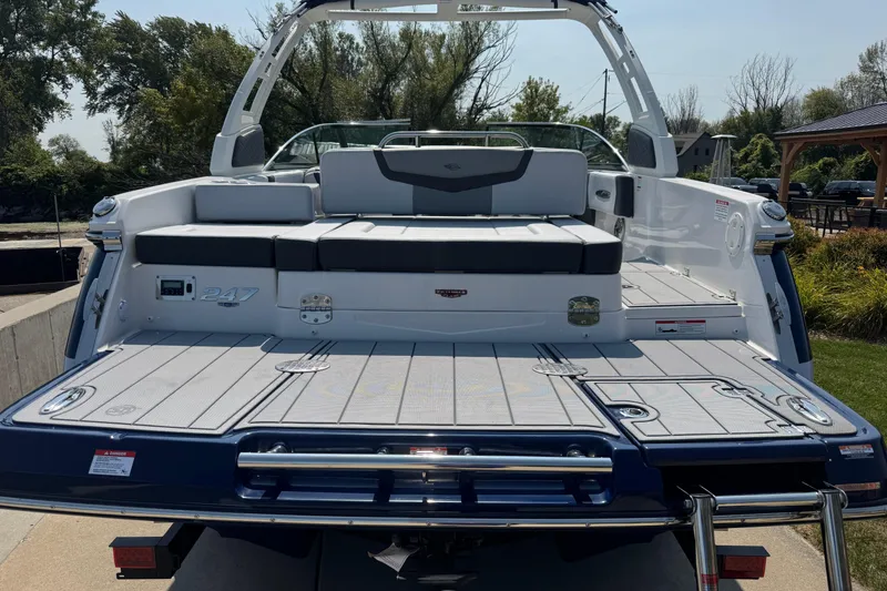 Slide: The Image of 2025 Chaparral 247 SSX boat, rear view, showcasing spacious deck and seating. - 7