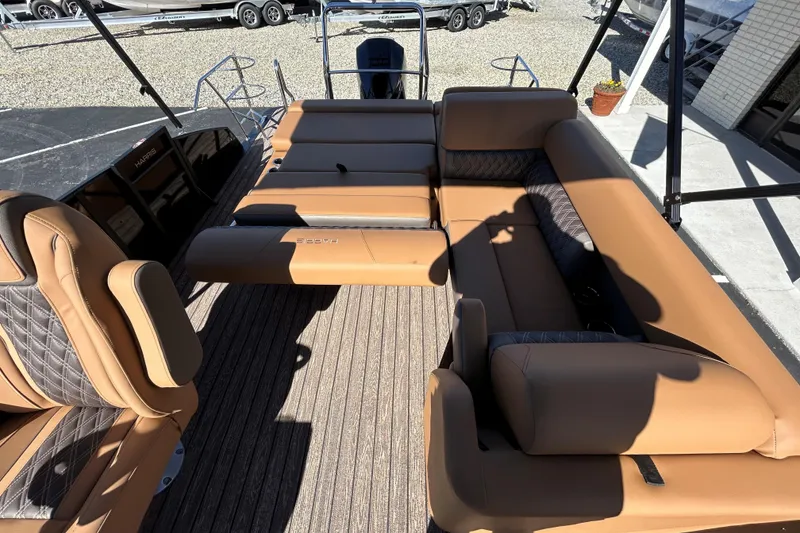 Slide: The Image of 2026 Harris FloteBote Cruiser 230 SL with luxurious tan seating and spacious deck. - 10