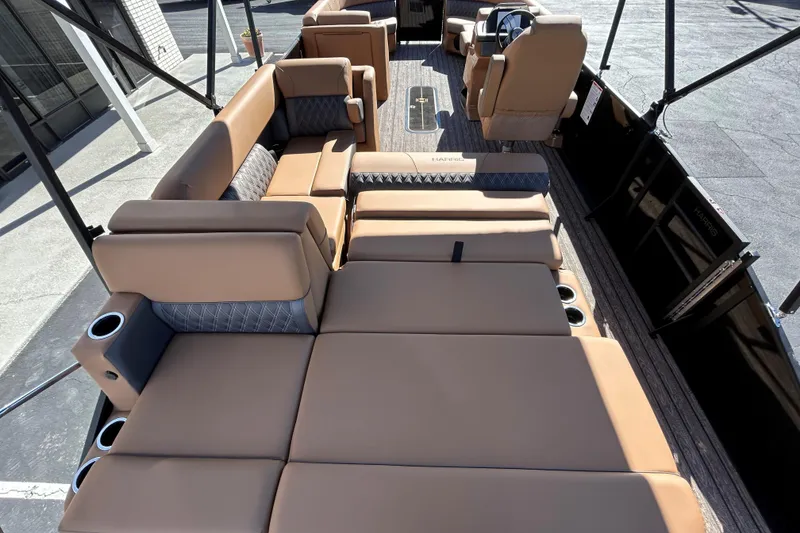 Slide: The Image of 2026 Harris FloteBote Cruiser 230 SL interior with luxurious tan seating and cup holders. - 16
