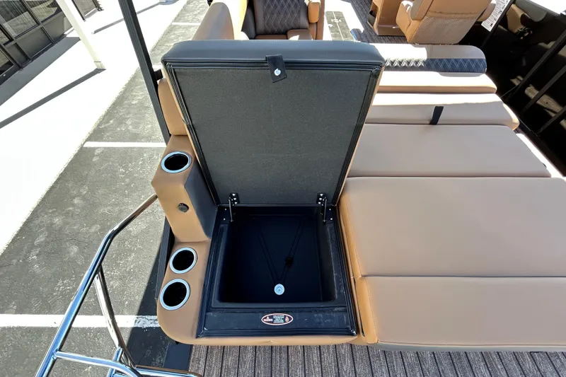 Slide: The Image of 2026 Harris FloteBote Cruiser 230 SL with open storage compartment and cup holders. - 17