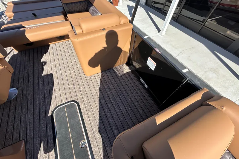 Slide: The Image of 2026 Harris FloteBote Cruiser 230 SL interior with tan seating and striped flooring. - 23