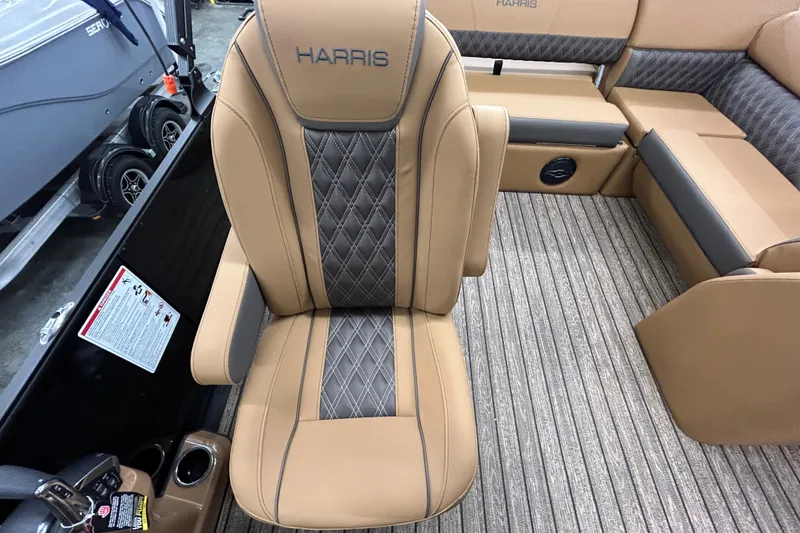 Slide: The Image of 2026 Harris FloteBote Cruiser 230 SL pontoon boat on trailer, under clear blue sky. - 3