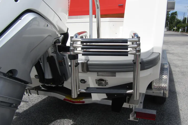 Slide: The Image of 2024 Nimbus T8 boat with stainless steel ladder and outboard motor on trailer. - 2