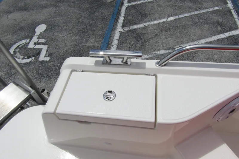 Slide: The Image of 2024 Nimbus T8 boat detail with cleat and storage compartment, near accessible parking space. - 28