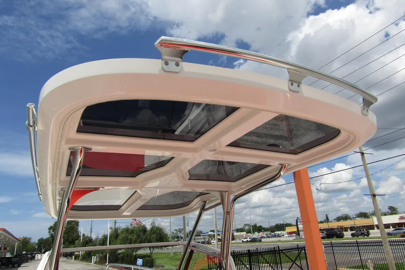 Slide: The Image of 2024 Nimbus T8 boat canopy with glass panels and metal supports under a blue sky. - 33