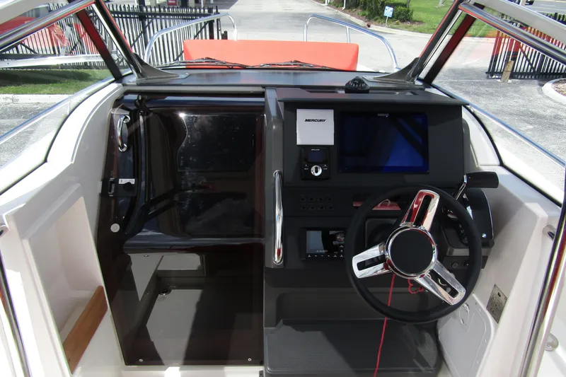 Slide: The Image of 2024 Nimbus T8 boat cockpit with modern steering and navigation controls. - 15