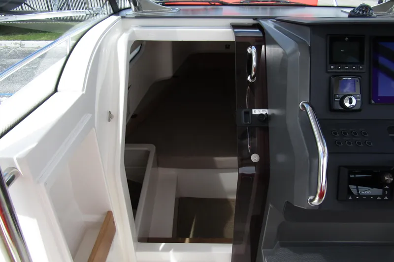 Slide: The Image of 2024 Nimbus T8 boat interior with control panel and cabin entrance. - 20