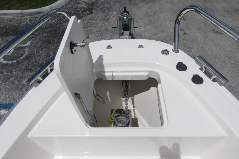 Slide: The Image of 2024 Nimbus T8 boat anchor compartment with open hatch and visible chain mechanism. - 9