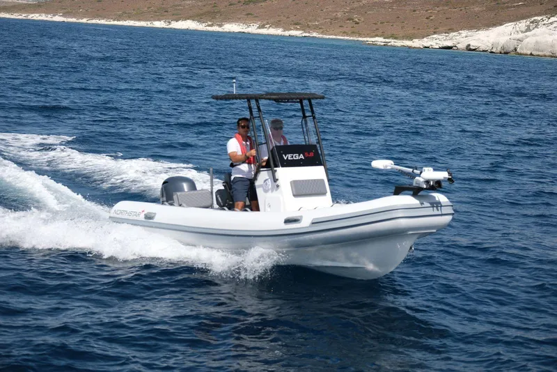 Slide: The Image of 2026 Northstar Vega 5.8 boat cruising on open water. - 2