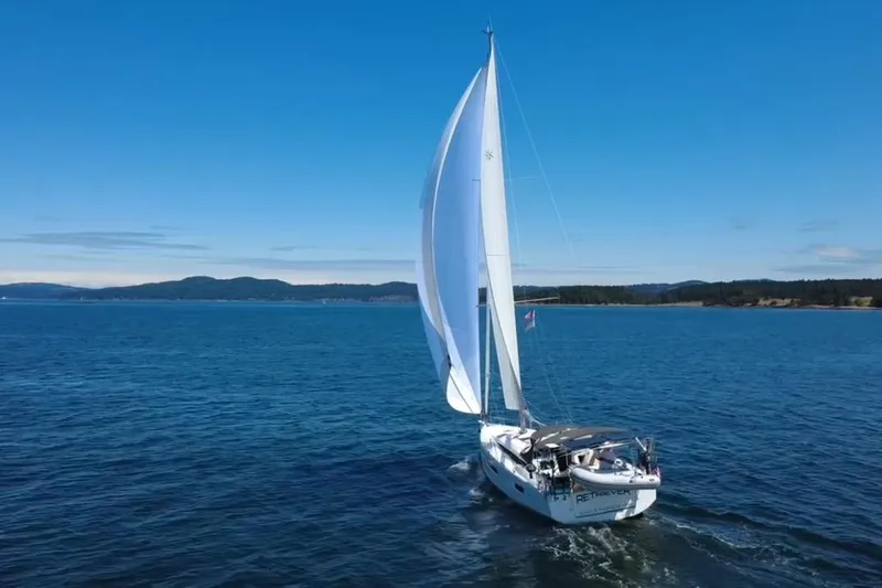 The Image of Sailing yacht Jeanneau Sun Odyssey 410, 2022 model, cruising on open water under clear blue skies. - 0