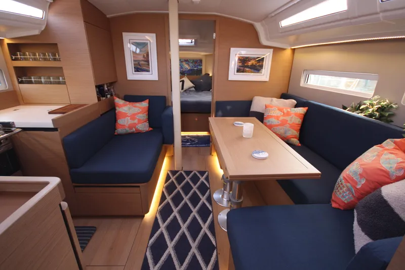 Slide: The Image of Interior of 2022 Jeanneau Sun Odyssey 410 yacht with modern seating and decor. - 11
