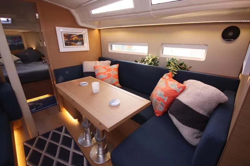 Slide: The Image of Interior of 2022 Jeanneau Sun Odyssey 410 sailboat with cozy seating and decorative pillows. - 14