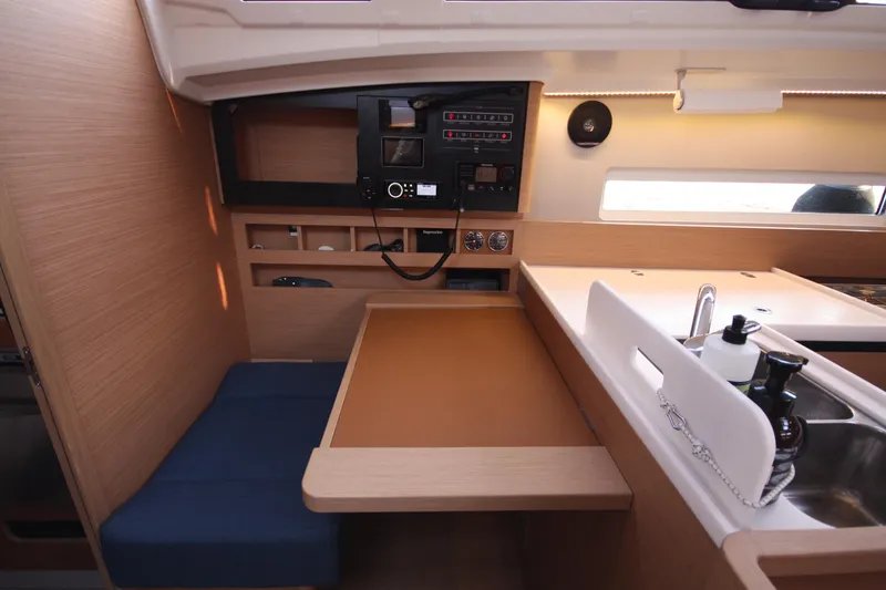 Slide: The Image of Interior of 2022 Jeanneau Sun Odyssey 410 yacht with modern navigation panel and seating area. - 15